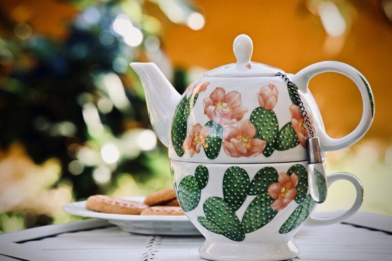 Image of stacked teapot and teacup with painted on cactus